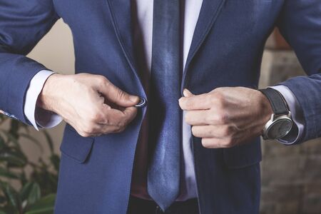 man hand suit button in office backgroundの写真素材