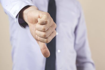 man finger bad sign on yellow background