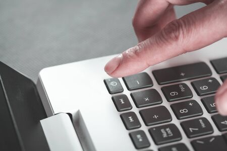 woman hand touching keyboard on the tableの写真素材