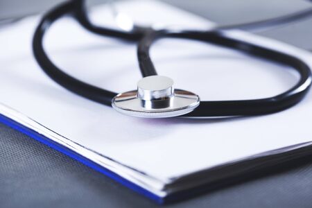 stethoscope on the document on the tableの写真素材