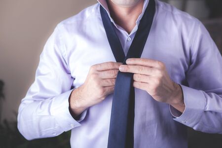 young business man hand tie with shirtの写真素材