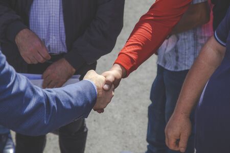 man each other by hand in street backgroundの写真素材