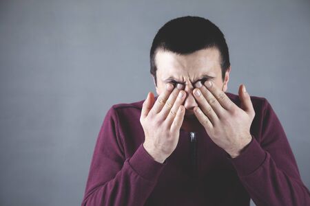 man hand close eye on the grey background