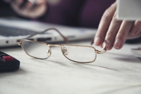woman hand computer with glasses on the table