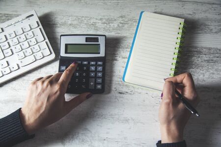 man hand pen with calculator on the table backgroundの写真素材