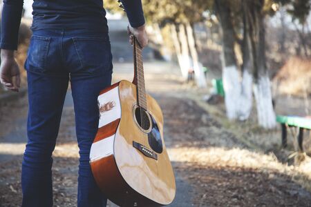 Young man plays beautiful music in natureの写真素材