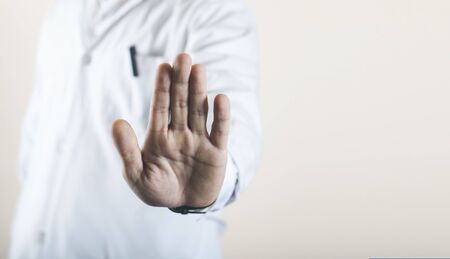 young doctor shows his hand to stop the virusの写真素材