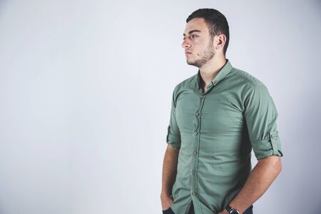 young man hand in pocket in studioの写真素材