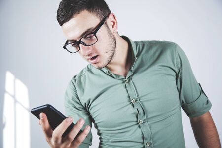 young business man hand smart phone in office