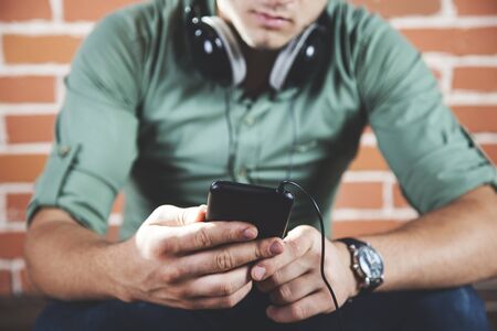 young man hand or ear earphone in studio