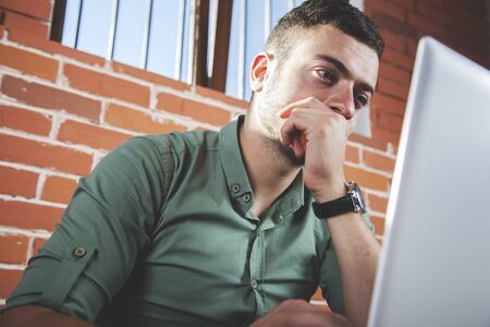 sad man notebook on the brick wall backgroundの写真素材