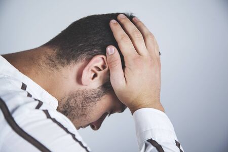 sad business man hand in head in office