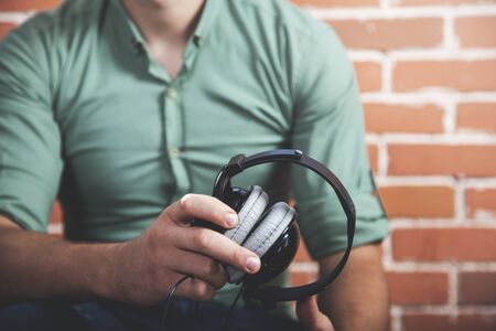 young man hand or ear earphone in studioの写真素材