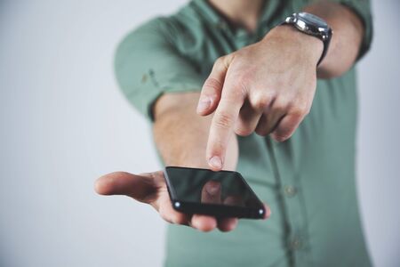 young business man  finger touching smart phoneの写真素材
