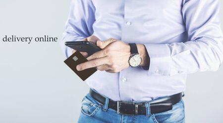 male hands using smart phone with mobile app for ordering food online on websiteの写真素材