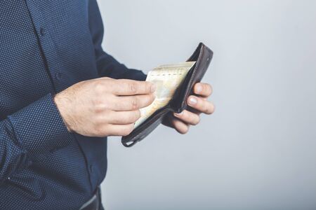 man takes out money from a walletの写真素材