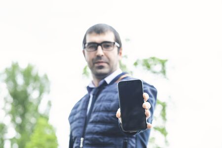 young man hand holding blank smartphone screenの写真素材