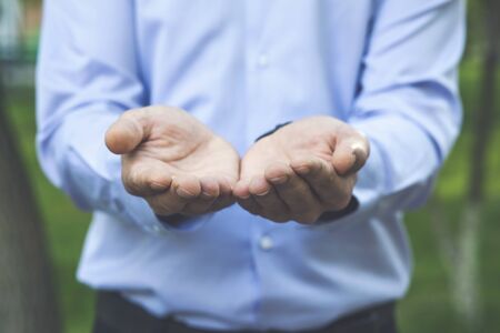 young business man empty palm on green backgroundの写真素材