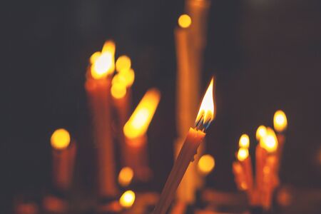Pray candle in orthodox church. Candle light flame.の写真素材