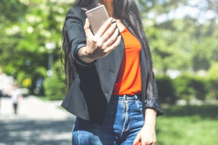 beautiful girl takes a selfie in the park