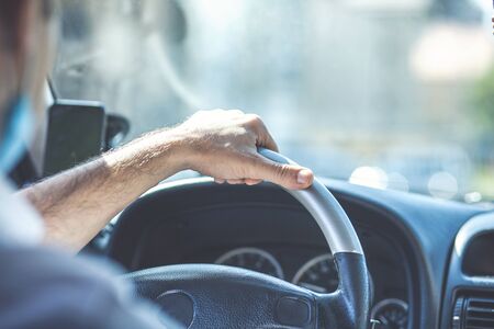 Young and joyful man drives his new carの写真素材