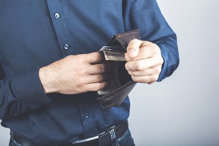 man takes out money from a wallet