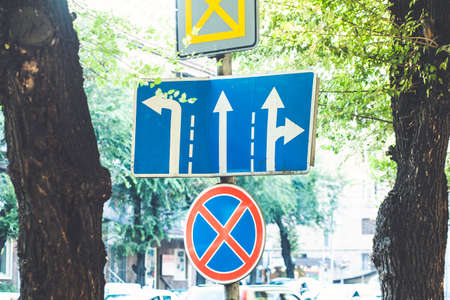 No parking, road sign is in front of pedestrian crossing. No parking and stopping on the road - road...
