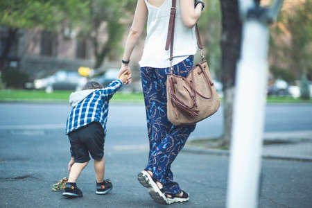 Mom and child walk around the city.