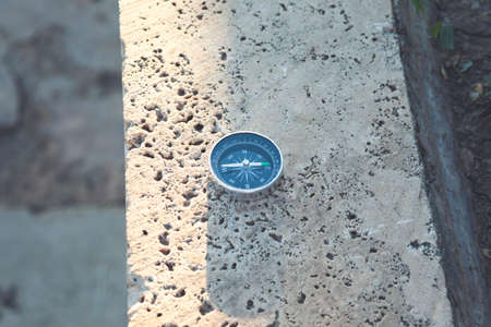 compass on a stone at the top of a mountain.の写真素材