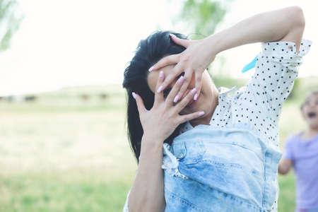 Beautiful young woman covers face with hands.の写真素材