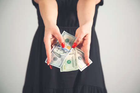 young fashion business woman hand money on gray background.の写真素材