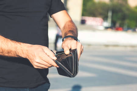 man takes out money from a walletの写真素材