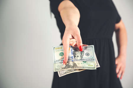 young fashion business woman hand money on gray background.の写真素材