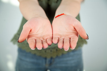 close up of womans cupped hands showing somethingの写真素材