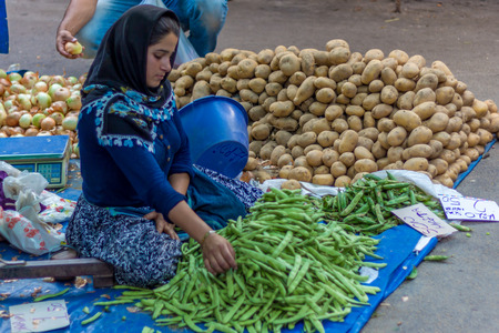 IZMIR, TURKEY - JUNE 26: Young woman seller in public market on June 26, 2015 in Izmirのeditorial素材