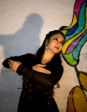 a beautiful classical dancer posing on a streetの写真素材