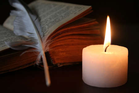 A Trio - Candle, Book and Plumeの写真素材