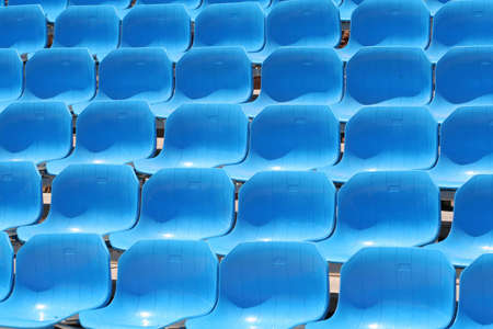 Several rows of blue stadium seatsの写真素材
