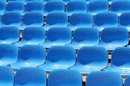 Several rows of blue stadium seatsの写真素材