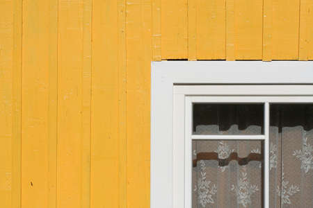 A wooden wall with a part of a window