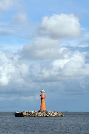 A landscape with a red lighthouseの写真素材