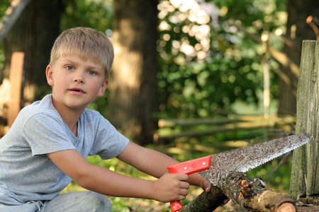 A child working with a sawの写真素材