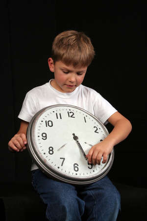 A portrait of a child with a clockの写真素材