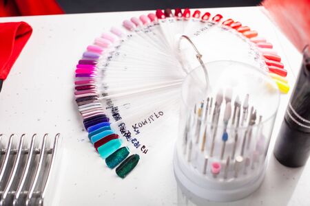 A palette of nail polishes, a circular sample of the color of gel-lacquer. Lots of colors to choose a manicure. Beauty salon.の写真素材