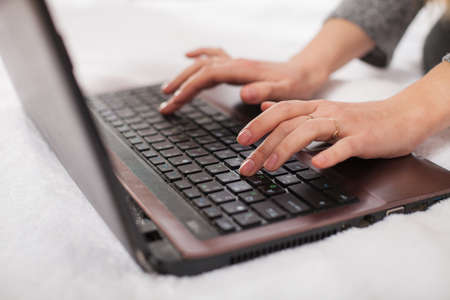 People, lifestyle, modern technology and communication concept. Young Caucasian female on laptop