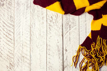 White wooden Christmas background. Empty space for text. Happy New Year. Christmas balls, garland, brown-red scarf.の写真素材