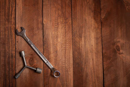 Keys, screwdrivers on a wooden brown background. Empty space for text.の写真素材