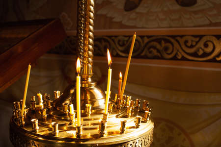Candlestick. Candles in the church, church candle stand. Candles are burning