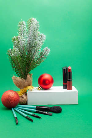 Christmas, New Year's background for make-up artist. Make-up brushes, Christmas decorations, spruce. Empty space for text.の写真素材