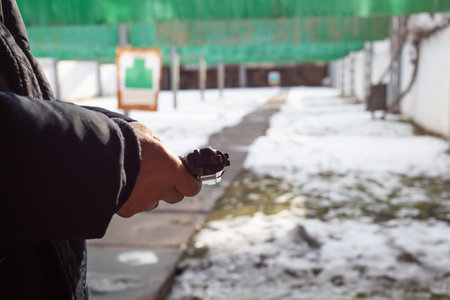 A man reloads a gun. Winter, out of the door, shooting range. Murder, danger, firearms. snow on the...